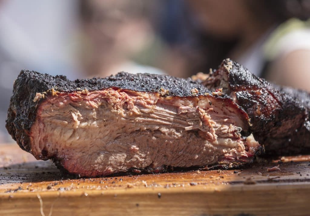 Pitmaster slicing championship barbecue at the Colorado BBQ Challenge, Copper Mountain