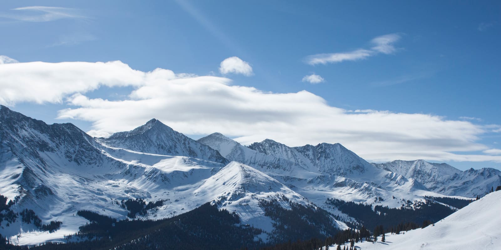 Snow-covered peaks of the Tenmile Range under a bright winter sky